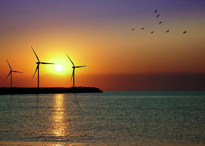 Water's Edge Greeting Card featuring the photograph Wind Turbine Farm In Sunset by Mariusfm77