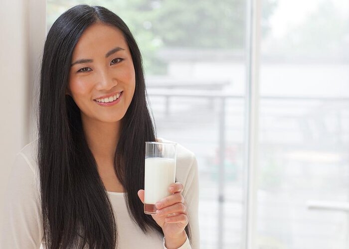 One Person Greeting Card featuring the photograph Woman Holding Glass Of Milk by Ian Hooton