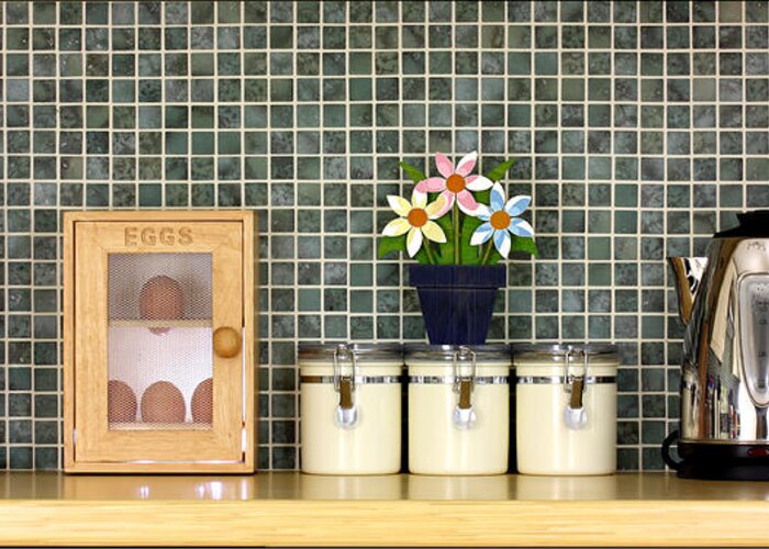Block Greeting Card featuring the photograph Clean kitchen worktop with kitchen items by Simon Bratt