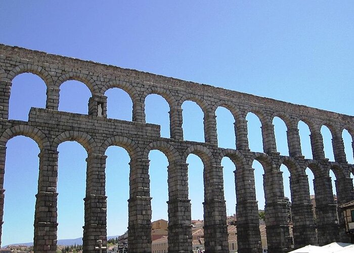 Segovia Greeting Card featuring the photograph Segovia Ancient Roman Aqueduct Architectural Granite Stone Structure IX With Arches in Sky Spain by John Shiron