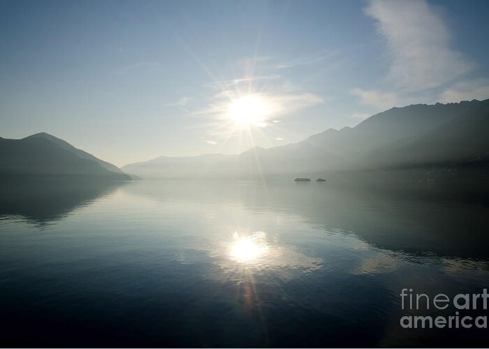 Sun Greeting Card featuring the photograph Sun reflections on a lake by Mats Silvan