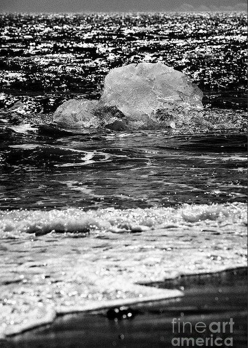 Ice Greeting Card featuring the photograph Iceberg washing up on black sand beach at jokulsarlon iceland #10 by Joe Fox