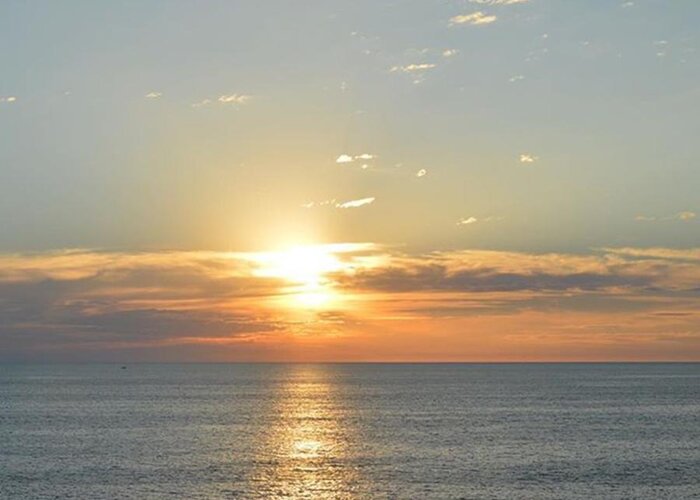 An Beautiful Sunset Over The Ocean Greeting Card featuring the photograph far away Sun by Josias Tomas