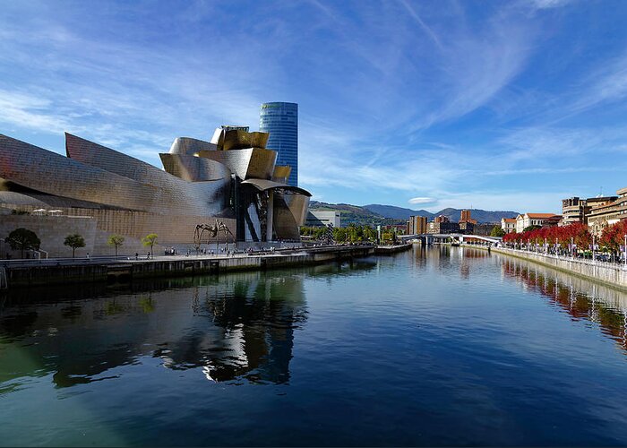 Spain Bilbao Guggenheim Museum Basque Country Frank Gehry Contemporary Architecture Nervion River City Daring And Innovative Curves Building Exterior Spectacular Building Deconstructivism Ferrovial Clad In Glass Greeting Card featuring the photograph Bilbao in autumn with blue skies next to the river Nervion by Andy Myatt