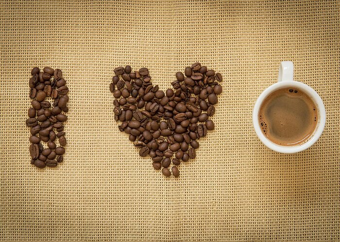 Cafe Greeting Card featuring the photograph Cup of fresh espresso coffee and beans by Michalakis Ppalis