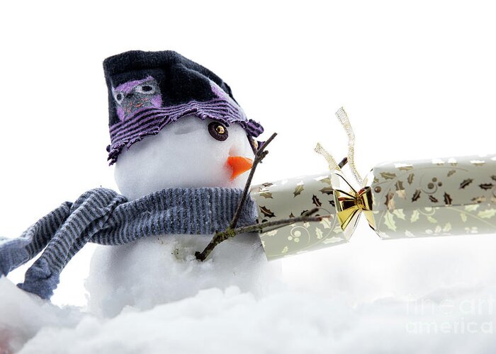 Snowman Greeting Card featuring the photograph Cute snowman pulling a cracker by Simon Bratt