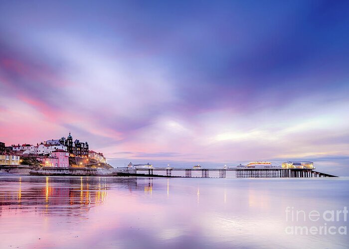 Cromer Greeting Card featuring the photograph Famous Cromer pier in Norfolk England with pink sunset by Simon Bratt