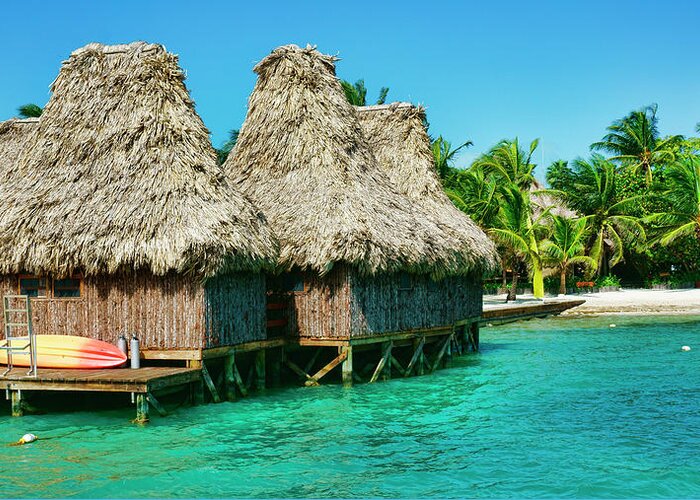 Belize Greeting Card featuring the photograph Grass Huts on the water of Ambergris Caye Belize by Waterdancer