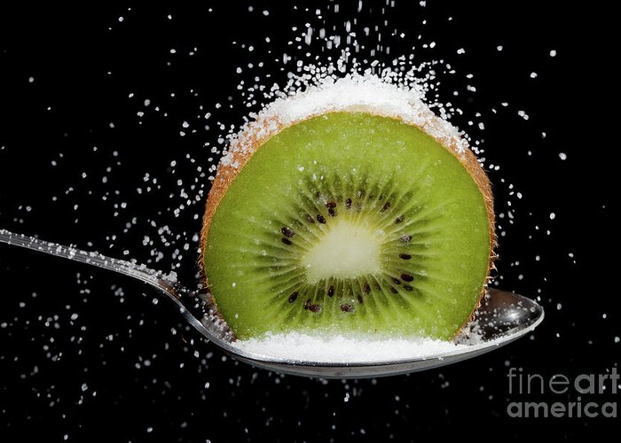 Kiwi Greeting Card featuring the photograph Kiwi fruit cut in half on a spoon with sugar by Simon Bratt