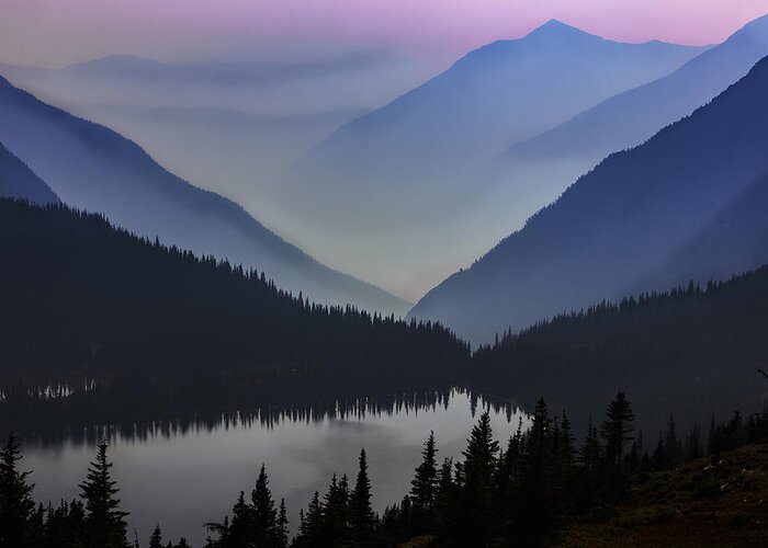 A Sunset View Of Mountains Obscured By Smoke In Glacier National Park. Greeting Card featuring the photograph Layers of Serenity by Mike Lang