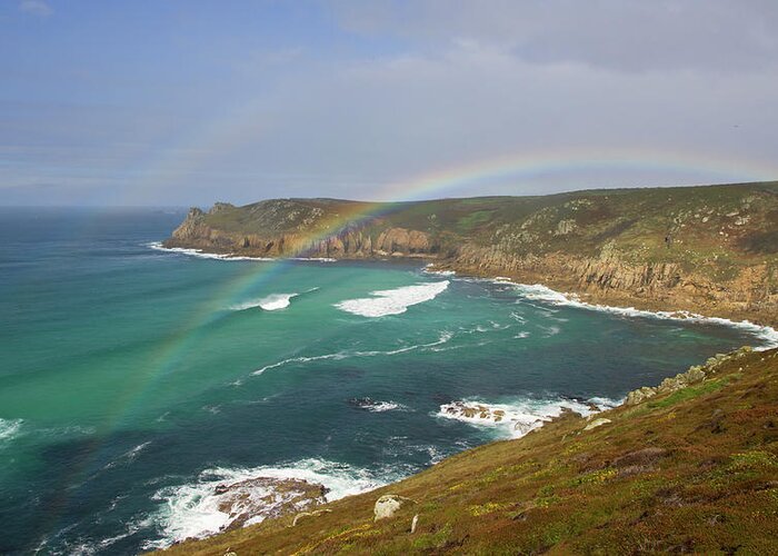 Nanjizal Cornwall Greeting Card featuring the photograph Rainbow over Nanjizal Bay in Cornwall by Pete Hemington