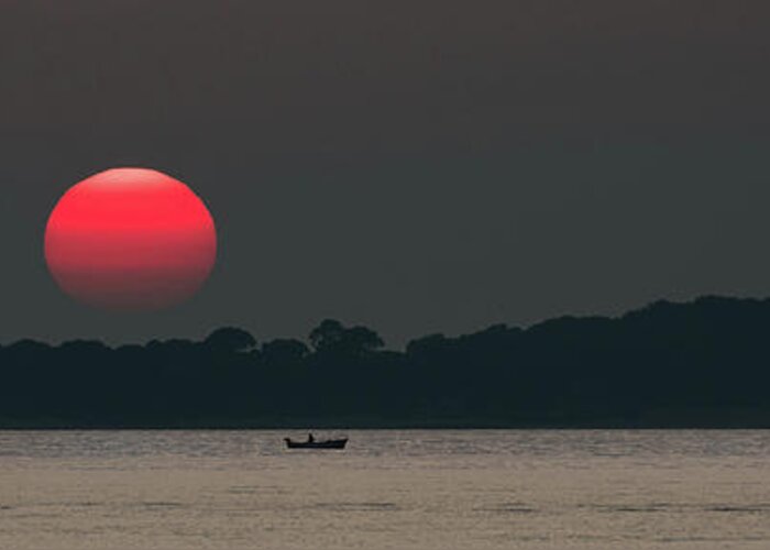 Sun Greeting Card featuring the photograph Red Sun at Sunset at Sea with Fishing Boat by Andreas Berthold