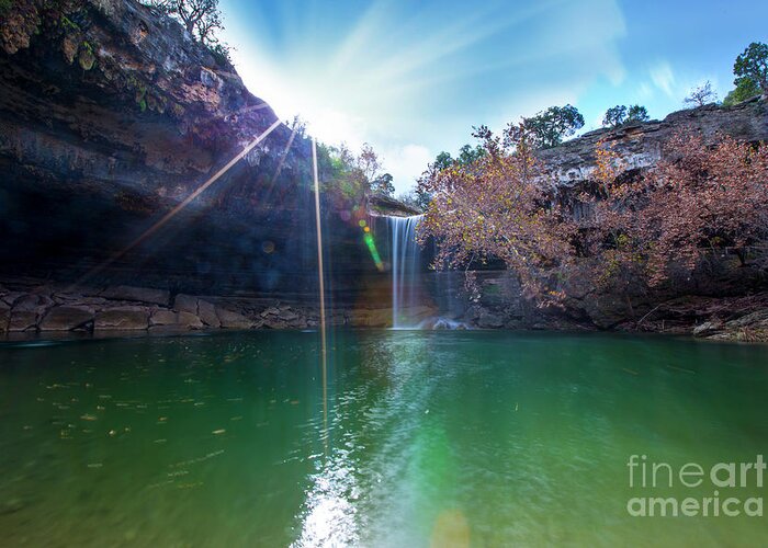 Hamilton Pool Nature Preserve Greeting Card featuring the photograph Sun rays shimmer through the cliffs at Hamilton Pool Nature Preserve as a beautiful 50-foot waterfall cascades down the pool by Dan Herron