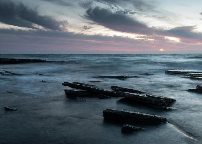 Seascape Greeting Card featuring the photograph Sunset on a rocky beach by Michalakis Ppalis