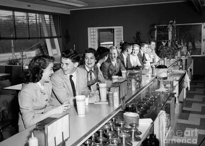 1950s Greeting Card featuring the photograph Teens At Soda Fountain Counter, C.1950s by H. Armstrong Roberts/ClassicStock