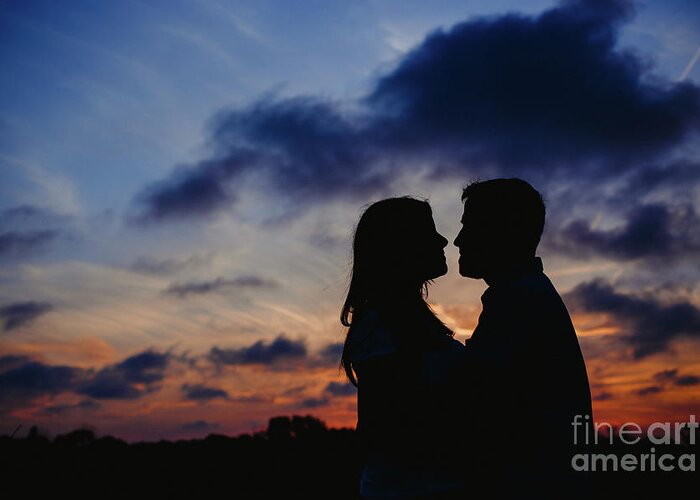 Background Greeting Card featuring the photograph Couple with cloud sky backlight #1 by Joaquin Corbalan