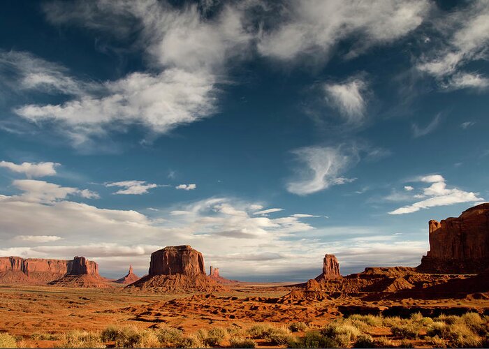 Scenics Greeting Card featuring the photograph Monument Valley With Dramatic Clouds #1 by Russell Burden