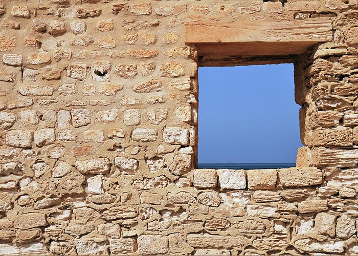Tunisia Greeting Card featuring the photograph Wall With Window Framing Blue Seascape #1 by Sami Sarkis