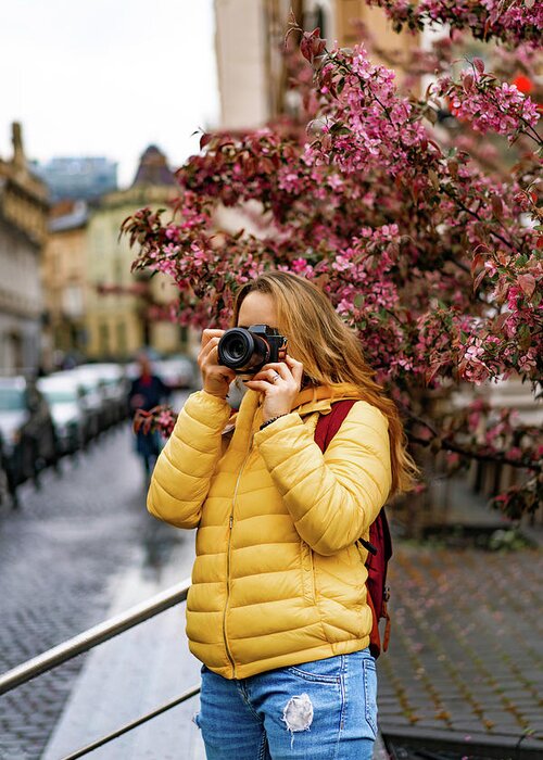 Sakura Greeting Card featuring the photograph Young Tourist Woman Taking Pictures With A Camera In Old Town Europe. #1 by Cavan Images