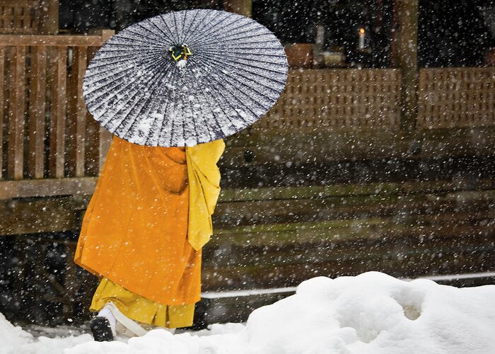 Shingon Buddhism Greeting Card featuring the photograph A Buddhist Monk Walks Through A Snow by Mint Images - Art Wolfe