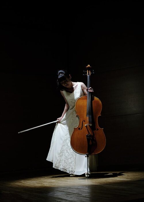 Shadow Greeting Card featuring the photograph A Female Cellist Making A Bow On Stage by Sot