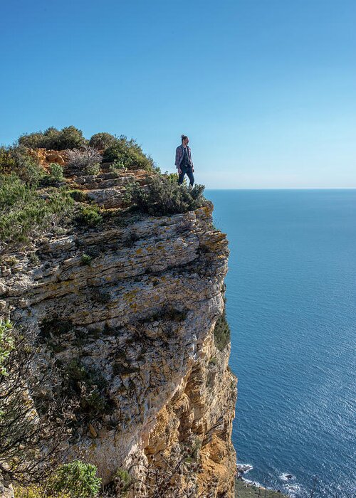 Cassis Greeting Card featuring the photograph A Men On A Cliff Facing The Mediterranean Sea by Cavan Images