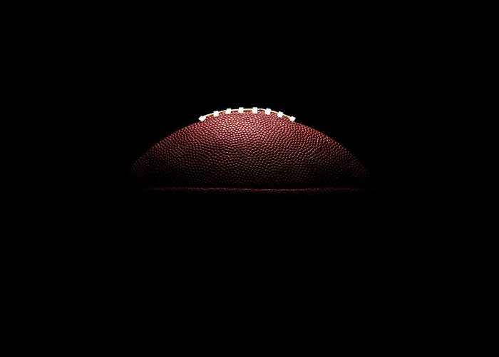 American Football Greeting Card featuring the photograph American Football Ball On Black by Thomas Northcut