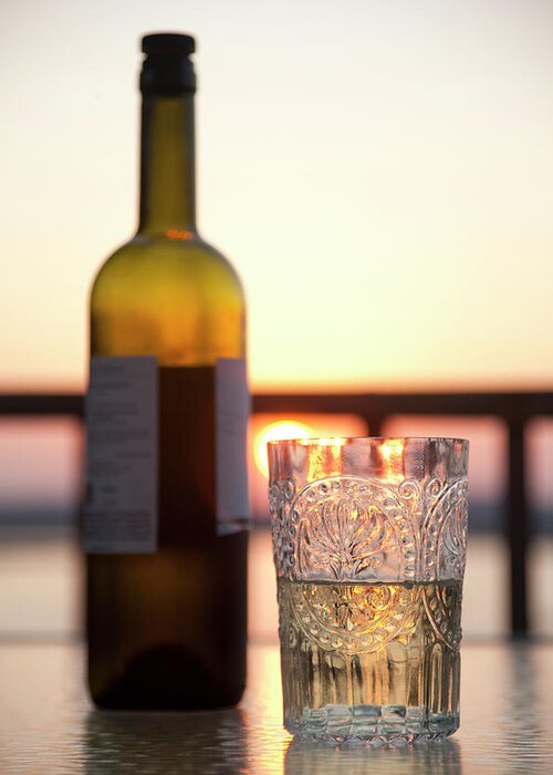 Tranquility Greeting Card featuring the photograph Antique Glass And A Bottle Of Wine At by Bill Boch