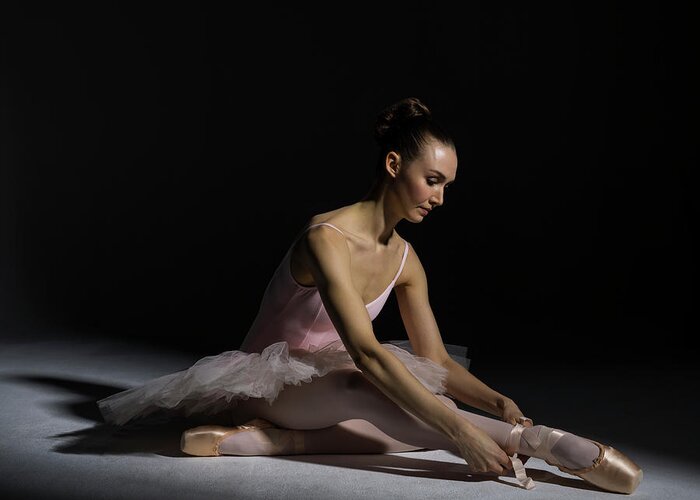 Tranquility Greeting Card featuring the photograph Ballerina Tying Pointe Shoe Ribbon by Nisian Hughes