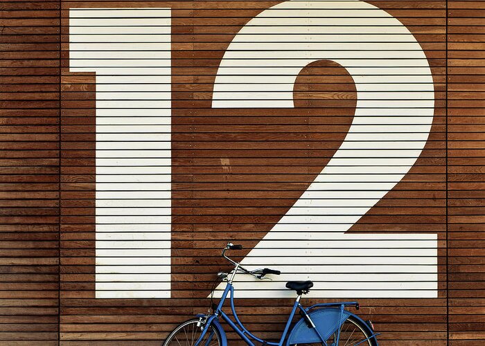 Leaning Greeting Card featuring the photograph Bike Against Big 12 by Sebastian Steiner