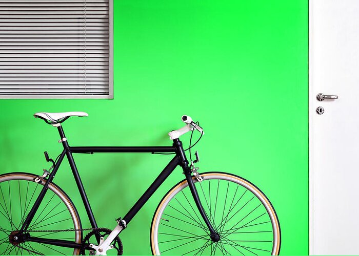 Racing Bicycle Greeting Card featuring the photograph Black Bicycle Green Wall by Carlosalvarez