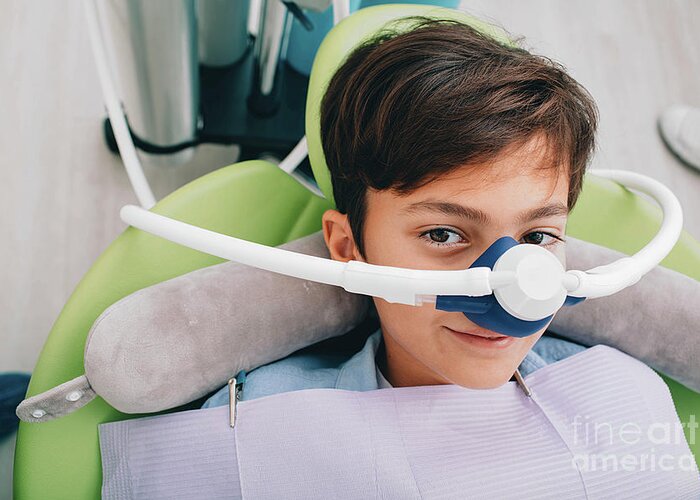 Dental Greeting Card featuring the photograph Child With Nitrous Oxide Mask At Dentist by Peakstock / Science Photo Library