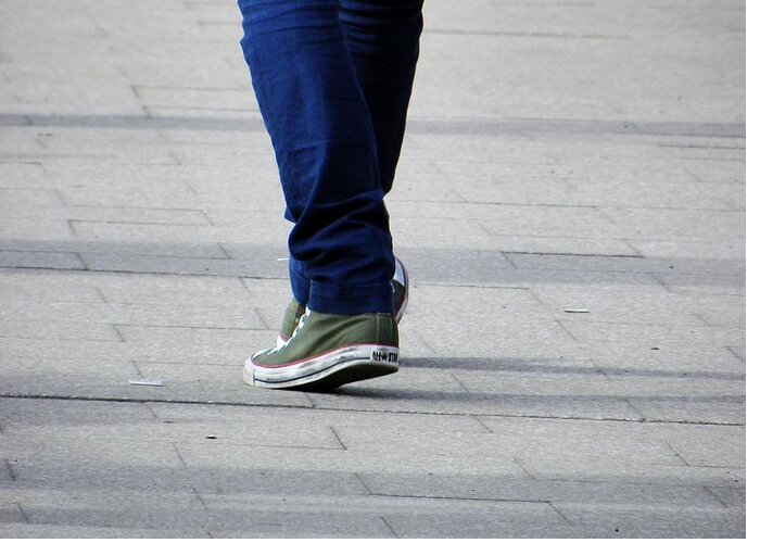 Street Photography Greeting Card featuring the photograph Chucks On The Move by Lachlan Main