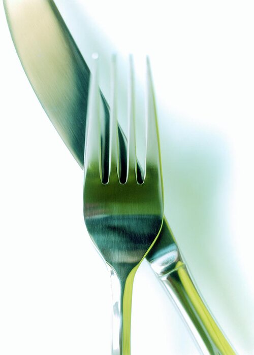 Empty Greeting Card featuring the photograph Close-up Of Fork And Knife On White by Amy Neunsinger
