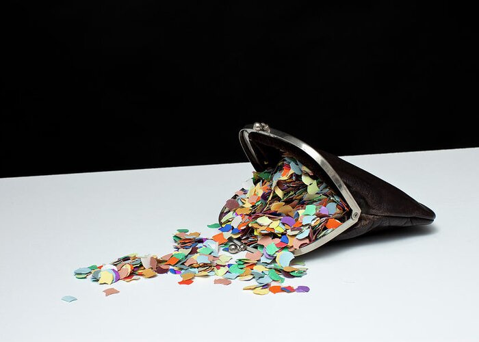 Change Purse Greeting Card featuring the photograph Confetti Spilling Out Of A Coin Purse by Benne Ochs