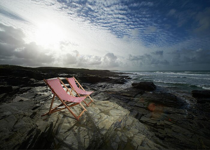 Tranquility Greeting Card featuring the photograph Deck Chairs On Rocky Coastline by Dougal Waters