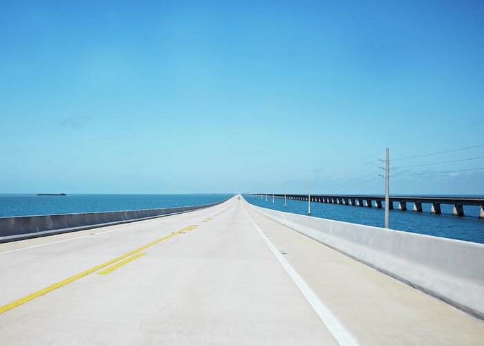 The Next Step Greeting Card featuring the photograph Endless Straight Road Over The Ocean by Ideeone