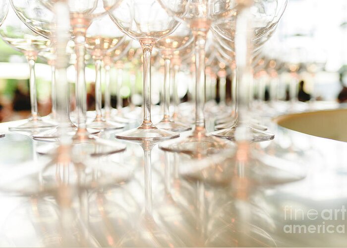 Abstract Greeting Card featuring the photograph Group of empty transparent glasses ready for a party in a bar. by Joaquin Corbalan