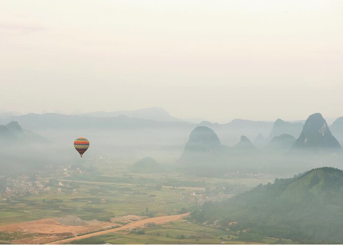 Tranquility Greeting Card featuring the photograph Hot Air Balloon Ride At Dawn Over Karst by Alex Linghorn