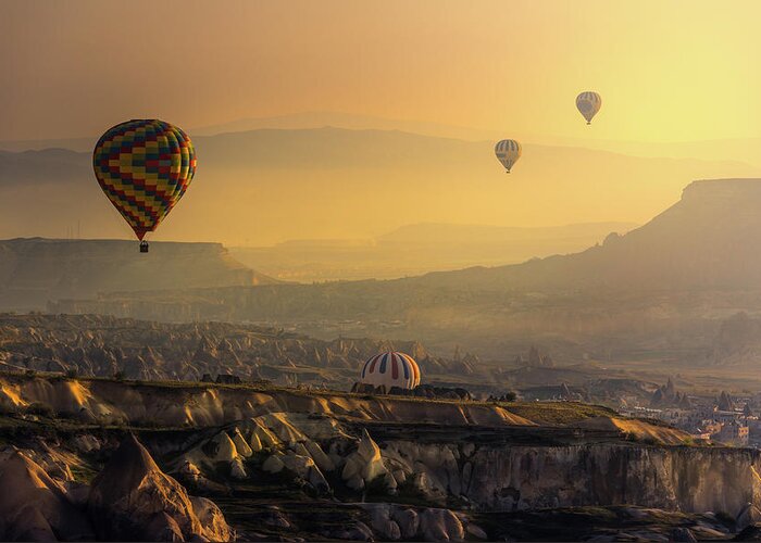 Tranquility Greeting Card featuring the photograph Hot Air Balloons Over Cappadocia by Coolbiere Photograph