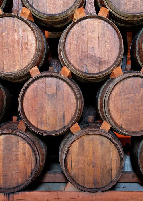 Fermenting Greeting Card featuring the photograph Wine Barrels Stacked Inside Winery by Yinyang