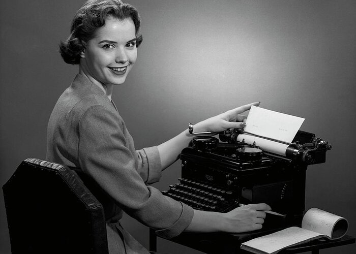 Working Greeting Card featuring the photograph Woman Working At Typewriter by George Marks