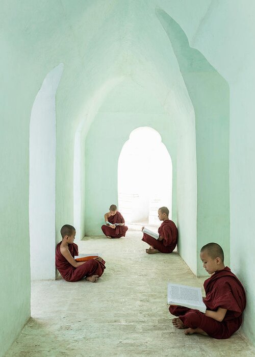 Arch Greeting Card featuring the photograph Young Buddhist Monks Reading In Temple by Martin Puddy