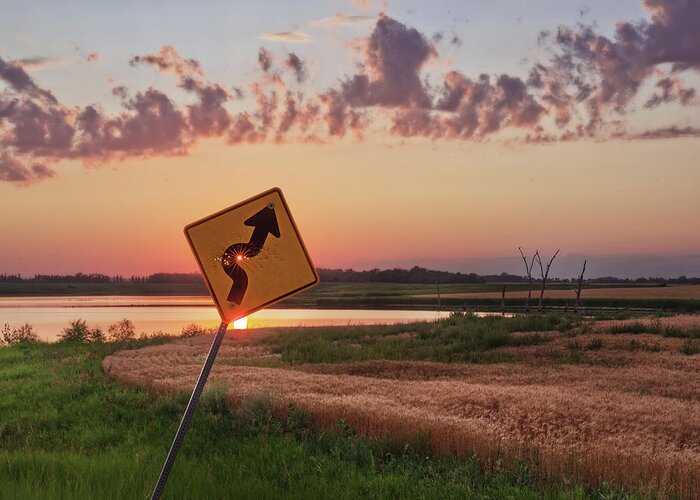 Sign Curve Scenic Landscape North Dakota Lake Syzygy Alignment Sun Pinhole Roadsign Hunting Bullet Humor Star Bullet Hole Shooting Shot Greeting Card featuring the photograph Dodged a Bullet - curve in road sign with sunlight through bullet hole by Peter Herman