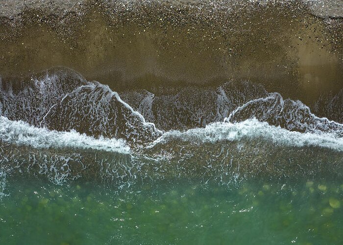 Waves Greeting Card featuring the photograph Aerial view ocean waves braking on a sandy beach. Nature background by Michalakis Ppalis