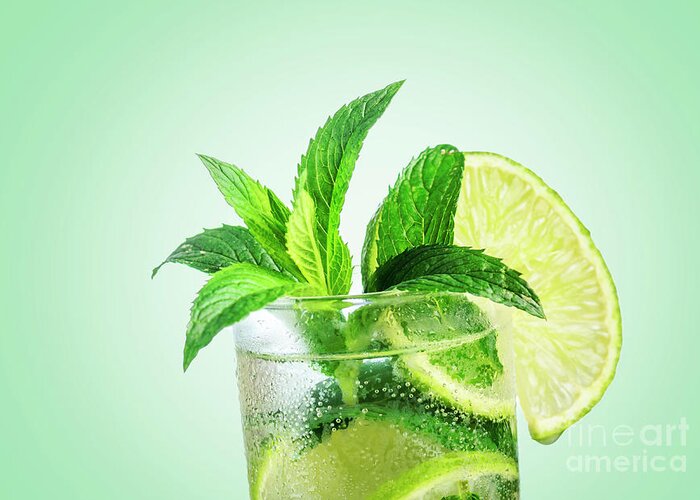Mojito Greeting Card featuring the photograph Closeup mojito cocktail with ice isolated over pastel background by Jelena Jovanovic