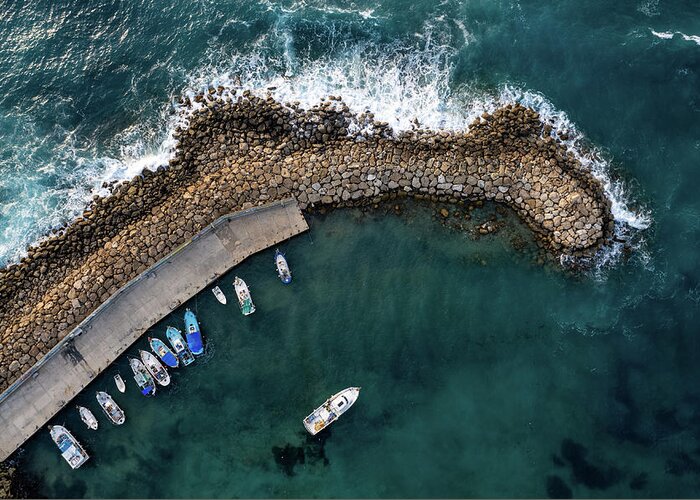 Fishing Harbor Greeting Card featuring the photograph Drone aerial fishing harbour with boats stormy waves, blue sea by Michalakis Ppalis