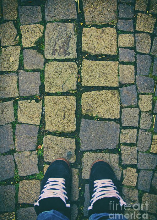 Sneakers Greeting Card featuring the photograph Feet in urban sneakers on cobblestones by Mendelex Photography