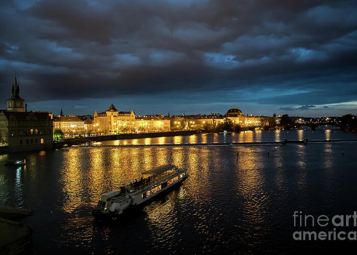 Architecture Greeting Card featuring the photograph Illuminated Moldova River With Ship And Buildings In The Night In Prague In The Czech Republic by Andreas Berthold