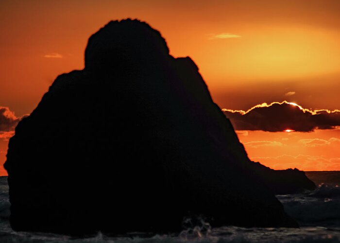 Oregon Coast Greeting Card featuring the photograph Large rock with sunset behind a ckoud by Jeff Swan